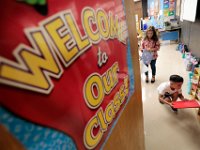 First graders prepare their folders in the cubbies inside their classrooms at the Casimir Pulaski school, as students across New Bedford return to school.  [ PETER PEREIRA/THE STANDARD-TIMES/SCMG ]